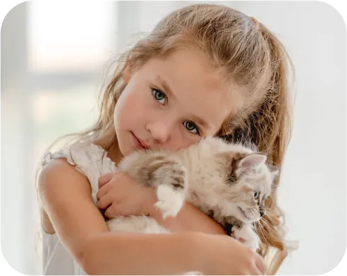 girl hugging a cat